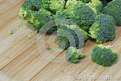 Raw Organic Broccoli on a Wooden Cutting Board Stock Photo