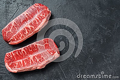 Raw organic meat Twagyu oyster top blade steak. Black background. Top view. Copy space Stock Photo