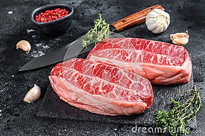 Raw organic meat Twagyu oyster top blade steak. Black background. Top view Stock Photo