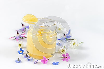 Raw organic royal jelly in a small bottle with litte spoon on small bottle on white background Stock Photo