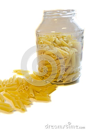 Raw pasta in glass pot isolated on white background Stock Photo