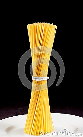 Raw pasta spaghetti on flat over old wood table Stock Photo