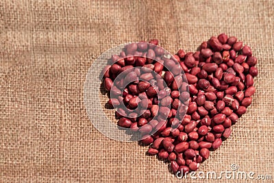 Raw peanuts forming heart Stock Photo