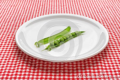 Raw peas on plate Stock Photo