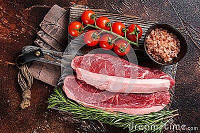 Raw Picanha meat steak, traditional Brazilian beef cut with thyme. Wooden background. Top view Stock Photo