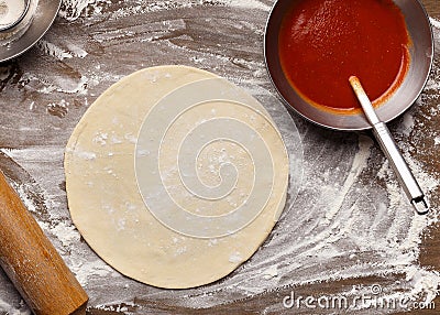 Raw Pizza Base And Ketchup. Rolled Out Dough Stock Photo