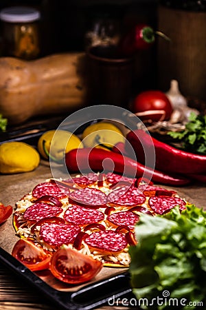 Raw pizza with cheese and salami Stock Photo