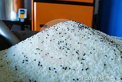 Raw plastic material white granules in metal box Stock Photo