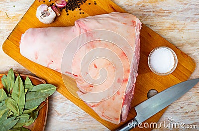 Raw pork leg with garlic, peppercorns, salt and bay leaves Stock Photo