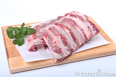 Raw pork ribs with herbs and spices on wooden board. Ready for cooking. Stock Photo