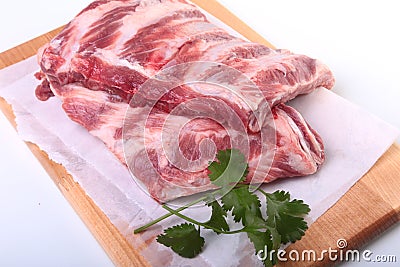 Raw pork ribs with herbs and spices on wooden board. Ready for cooking. Stock Photo