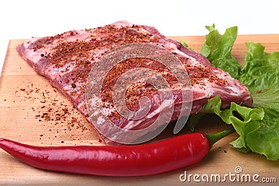 Raw pork ribs with herbs and spices on wooden board. Ready for cooking. Stock Photo