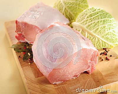 Raw pork roast with bone on a cutting board. Stock Photo
