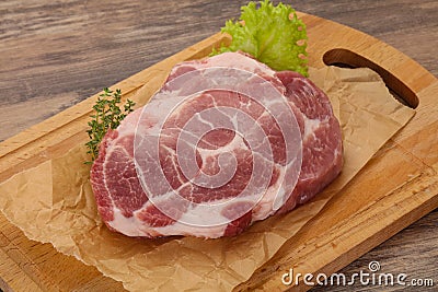 Raw pork steak over wooden board Stock Photo