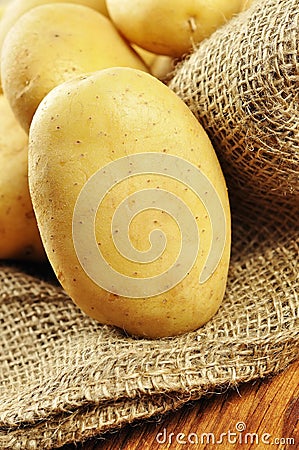 Raw potatoes in jute sack, closeup Stock Photo