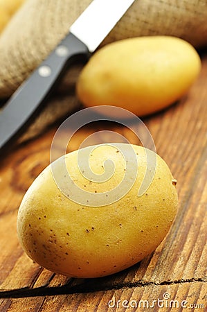 Raw potatoes in jute sack, selective focus Stock Photo