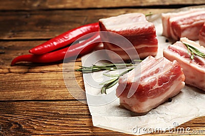 Raw ribs with rosemary on wooden table. Space for text Stock Photo