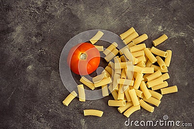 Raw Rigatoni Pasta with a Tomato Stock Photo Stock Photo