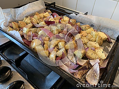 Raw Root vegetables roasted on a baking tray landscape Stock Photo