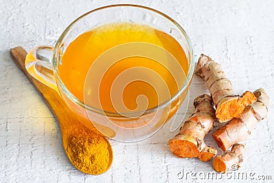 Raw roots of tumeric and tea on white planks detox concept Stock Photo