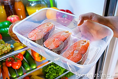 Raw Salmon steak in the open refrigerator Stock Photo