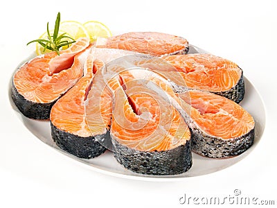 Raw salmon steaks on a plate Stock Photo