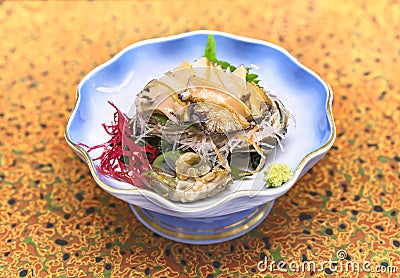 Japanese sashimi of fresh Awabi abalone with algae, radish, shiso and wasabi. Stock Photo