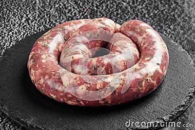 raw sausage in a round shape for grilling or roasting Stock Photo