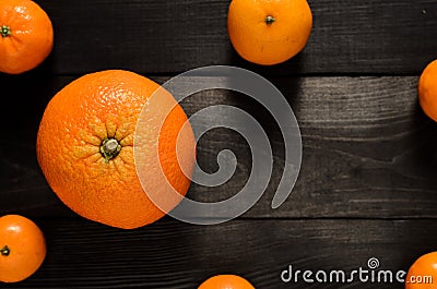 Raw several mandarins and orange isolated on black wooden background Stock Photo