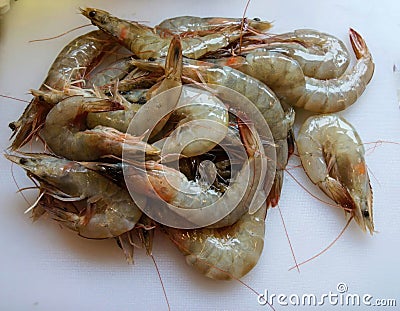 Raw shrimp, on cutting board Stock Photo