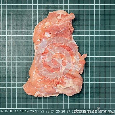 Chicken thigh ,leg meat on a line board. Raw skinless boneless chicken thigh, for cooking. Stock Photo
