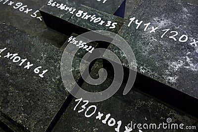 Raw steel bricks after thermal hardening with black slag Stock Photo