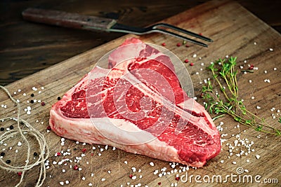 Raw t bone steak on wooden Board rustic style Stock Photo