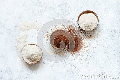 Raw teff grain and teff flour in a wooden bowls Stock Photo