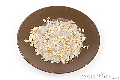 Raw thick-rolled oats on brown dish on white background Stock Photo