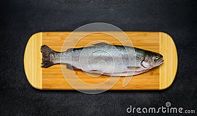 Raw Trout Fish on Wooden Chopping Board Stock Photo