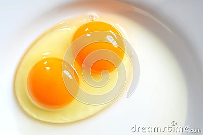 Raw two-yolk egg on the plate Stock Photo