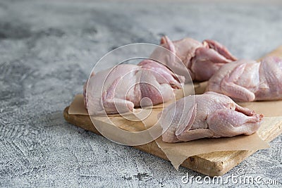 Raw uncooked quail. raw meat quails ready for cooking on a cutting board with copy space Stock Photo