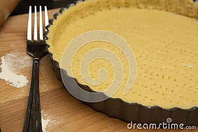 Raw, uncooked tart pie preparation, dough. Cooking apple, fruit pie. Cookign process. Kitchen table Stock Photo