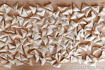 Raw, uncooked triangle shaped manti. traditional turkish food. turkish ravioli Stock Photo