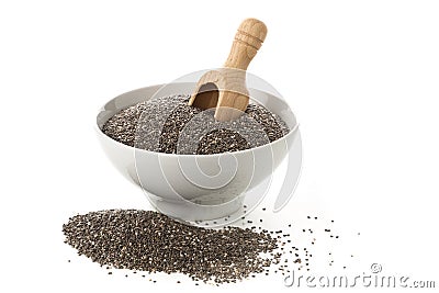 Raw, unprocessed, dried black chia seeds in white bowl with wood Stock Photo