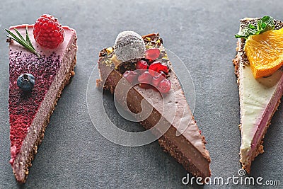 Raw vegan cakes with fruit and seeds, decorated with flower, product photography for patisserie Stock Photo