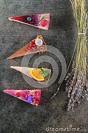 Raw vegan cakes with fruit and seeds, decorated with flower, product photography for patisserie Stock Photo