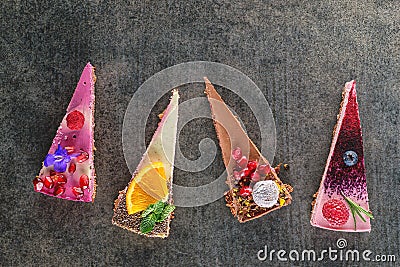 Raw vegan cakes with fruit and seeds, decorated with flower, product photography for patisserie Stock Photo