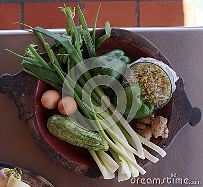 Raw vegetables and eggs in oval dish Stock Photo