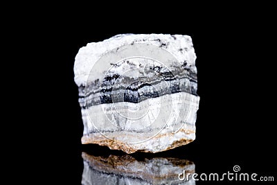 Raw white calcite mineral stone in front of black background Stock Photo