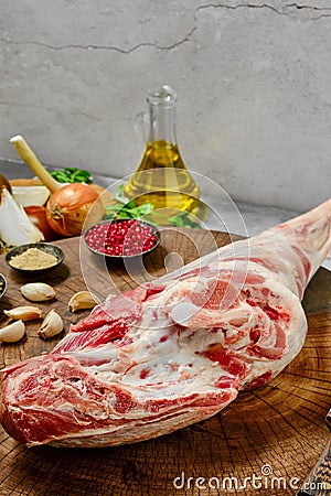 Raw whole lamb leg chump on with ingredients closeup Stock Photo