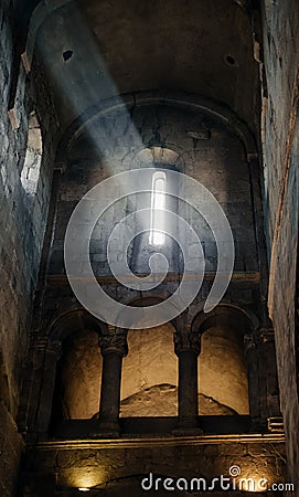 .a ray of light breaks out from a high window in an ancient temple Stock Photo