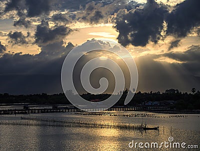 A ray of sunlight breaking through dark clouds Stock Photo