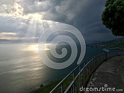 Ray of sunshine piercing through heavy clouds on the lake LÃ©man Stock Photo